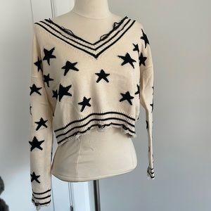 Chelsea ivory and black star sweater distressed
